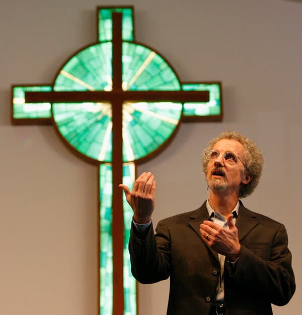 Author Philip Yancey looking thoughtfully away from the camera in a portrait.