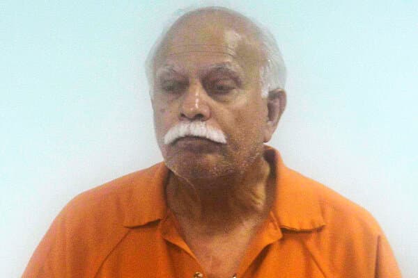 Dr. Javaid Perwaiz standing in a medical setting, facing allegations of unnecessary surgeries.