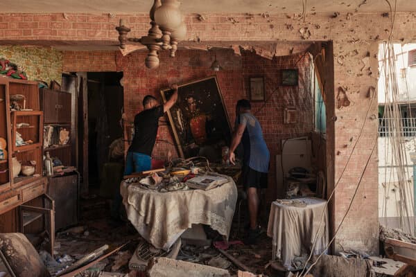 A crowd of people in Latin America holding political signs and flags.