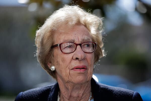 A portrait of Eva Schloss, the stepsister of Anne Frank, looking at the camera.