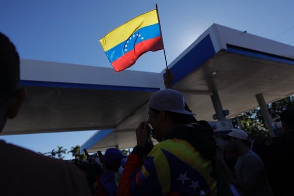 A gathering of Venezuelan American activists and political figures in Miami, protesting the Maduro regime and advocating for US intervention.