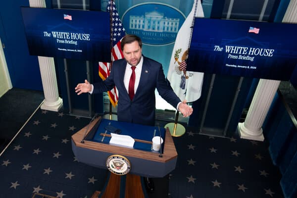 Vice President Vance speaking at a podium regarding the new Justice Department fraud initiative.