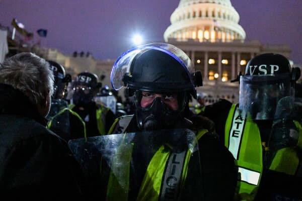 Senators viewing a new plaque honoring officers who protected the Capitol on January 6th