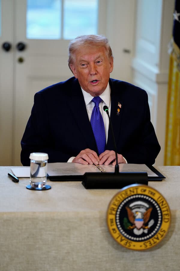 Oil executive reviewing documents with Venezuela map in background