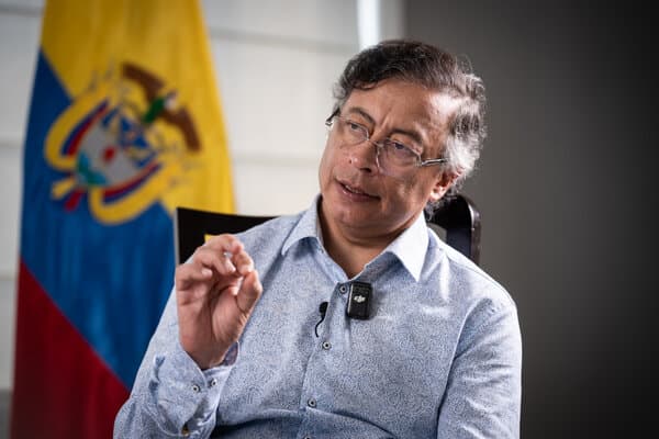 Colombian President Gustavo Petro looking concerned while speaking on the phone